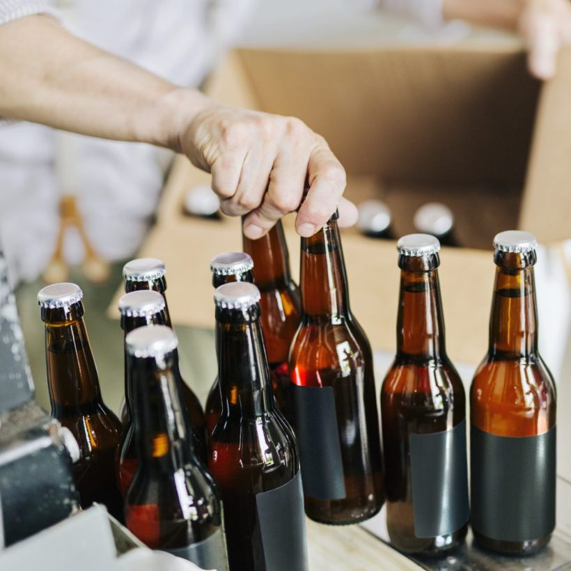 Brewery worker preparing beer bottles